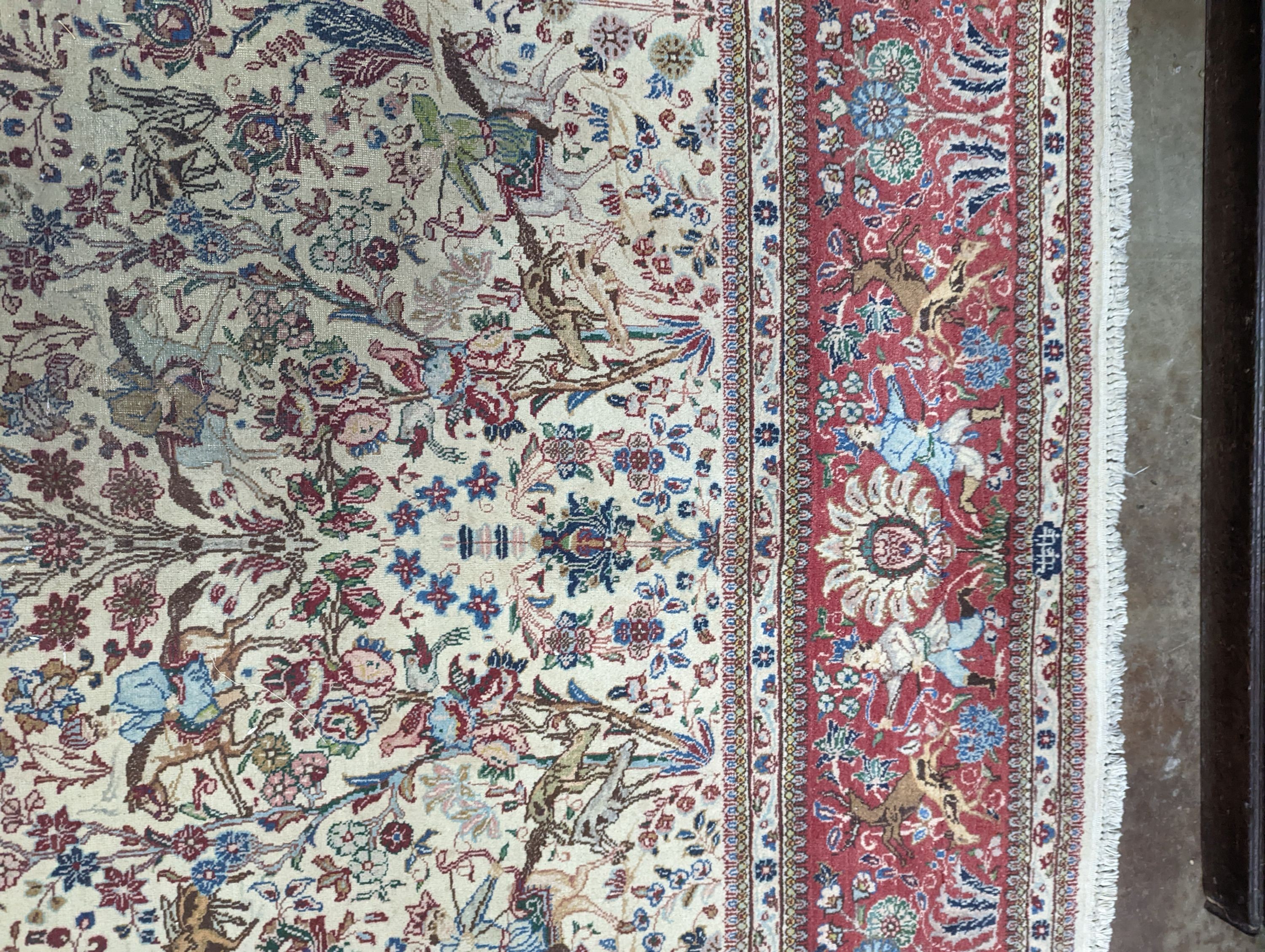 A Tabriz ivory ground pictorial rug (signed), 390 x 294cm